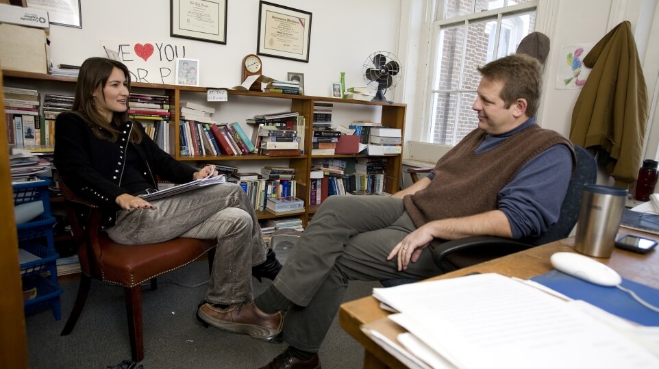 MC professor and student in an office