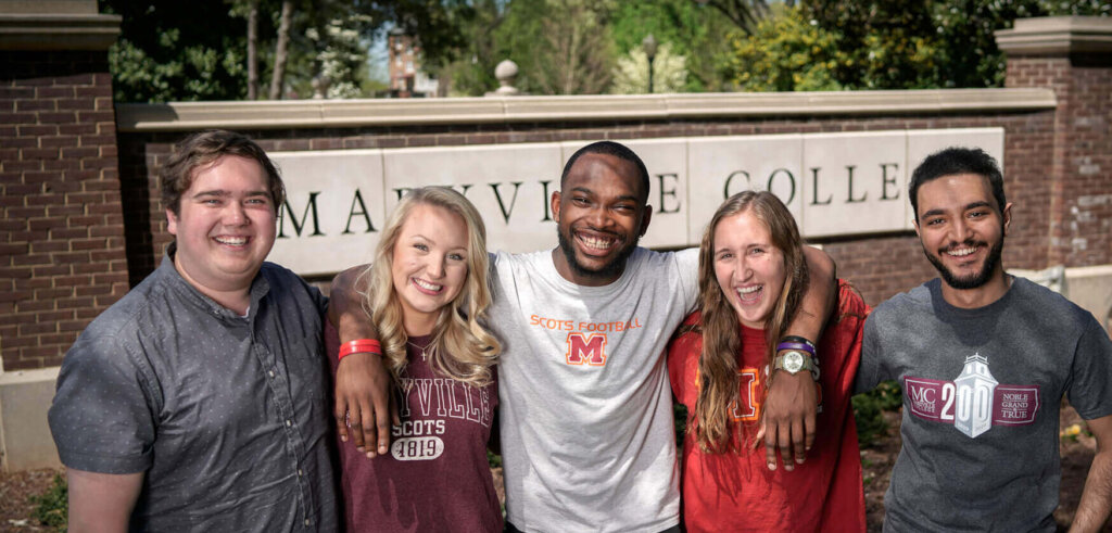 Photo of MC students at college entrance sign