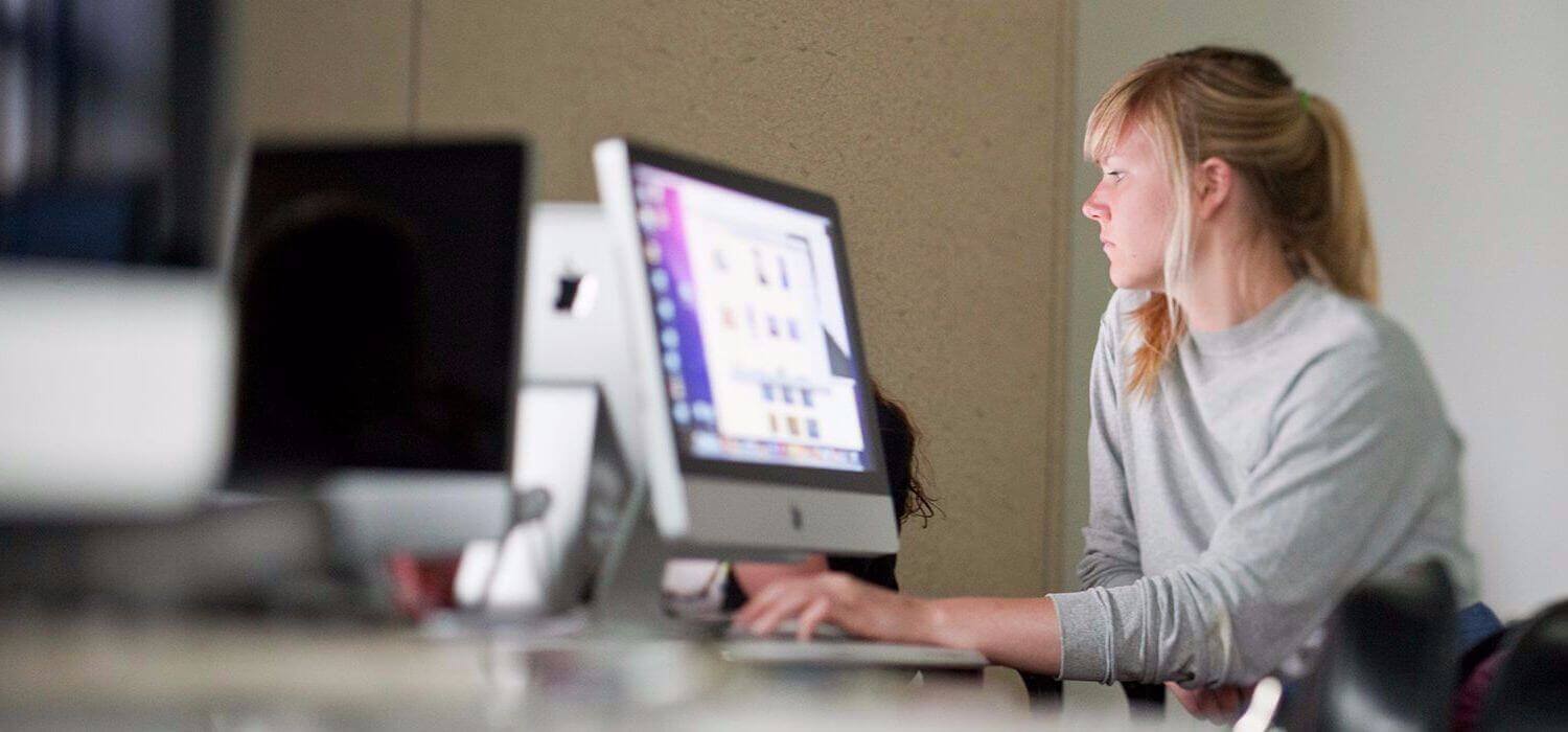 photo of student working at computer in Design lab