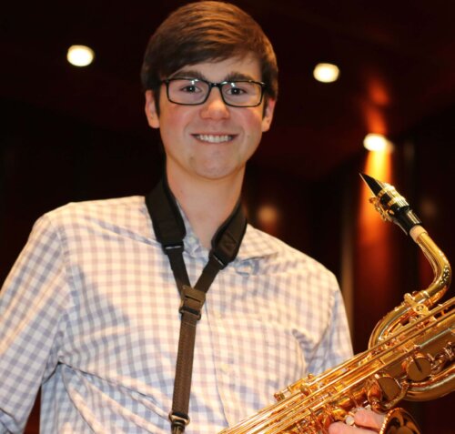 student holding a saxaphone