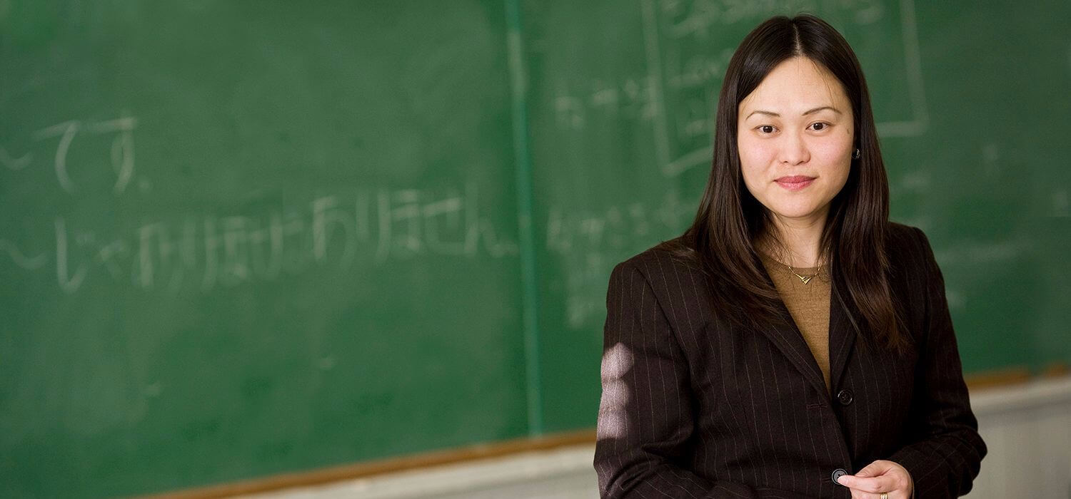 foreign languages student in front of chalkboard