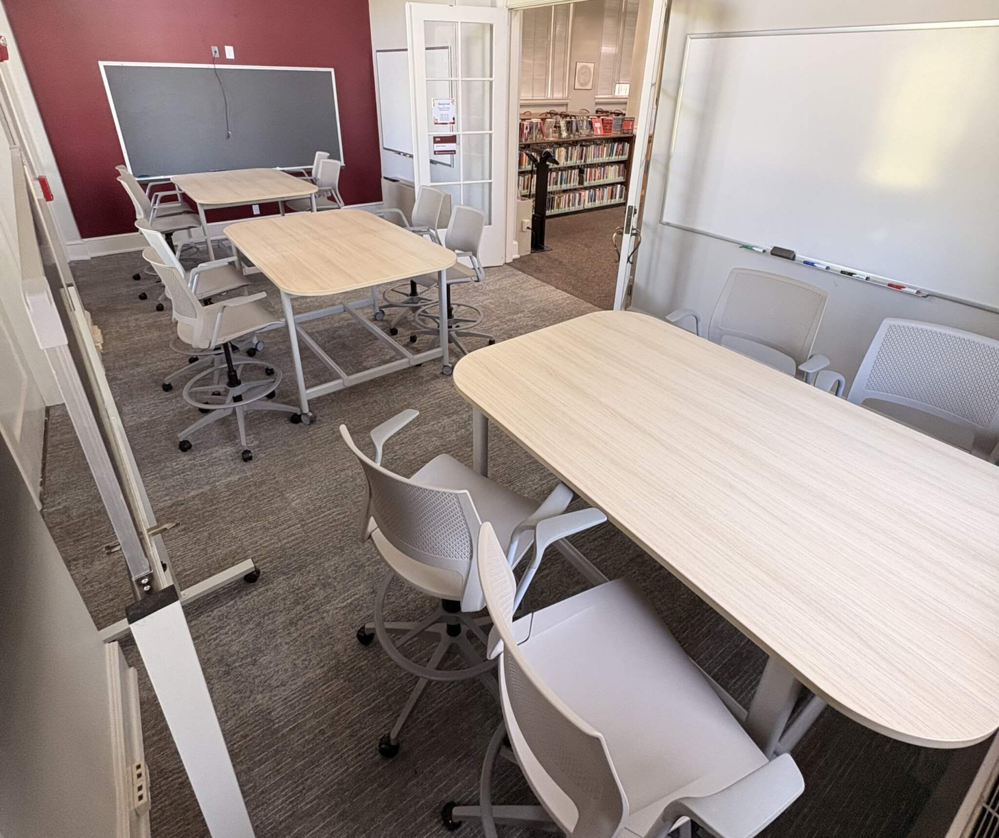Three mobile tables and twelve rolling stools stand around Study Room 1.