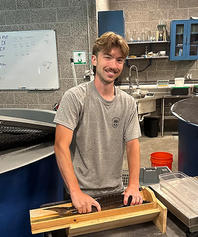 Photo of Noah Sikes, a recent graduate who majored in Biology.