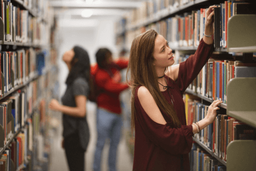 Photo of maryville college students in library stacks