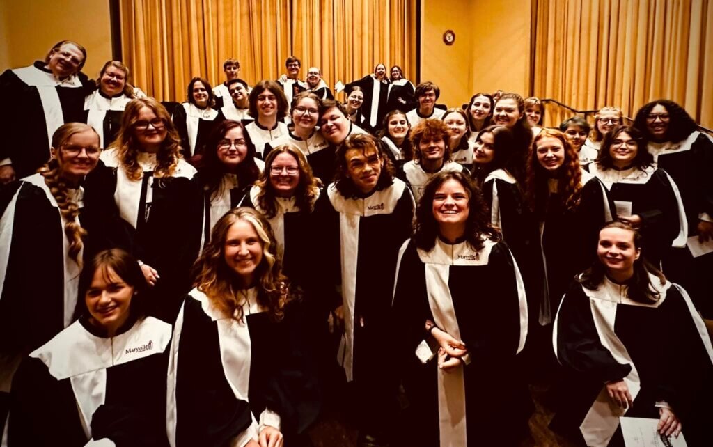 The concert choir in choir robes before Convocation 2023.