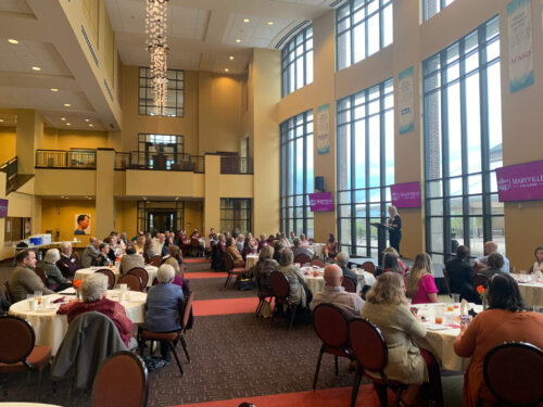 Members of the BCAA attending a dinner in the foyer of the Clayton Center for the Arts on the MC campus.