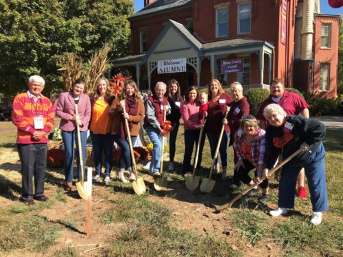 Members of the BCAA digging a hole to plant a tree outside Willard House on the MC campus
