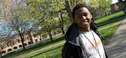 student standing outside smiling