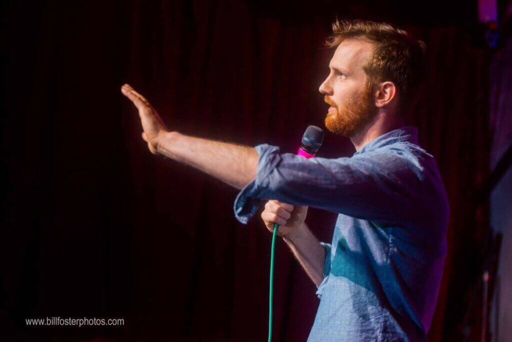 Photo of Drew Morgan on stage talking