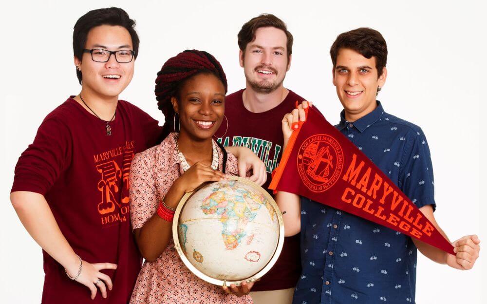 Photo of four international students with a globe