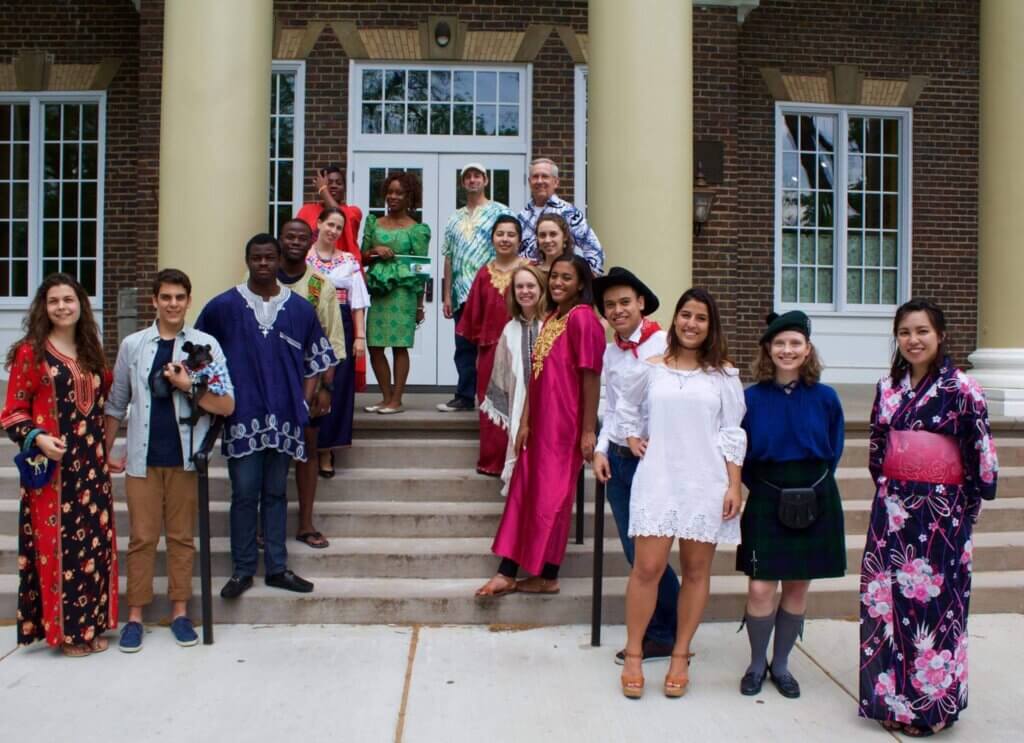 International students in a group on the steps of Pearsons Hall