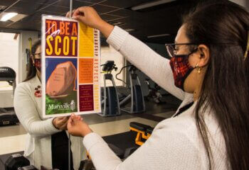 Photo of Doniqua Flack '15 hanging Covenant poster