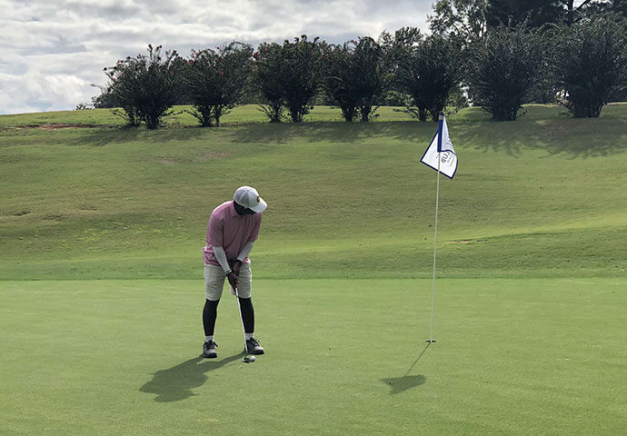 Photo of Drew Collins '20 playing golf