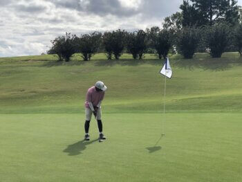 Photo of Drew Collins playing golf