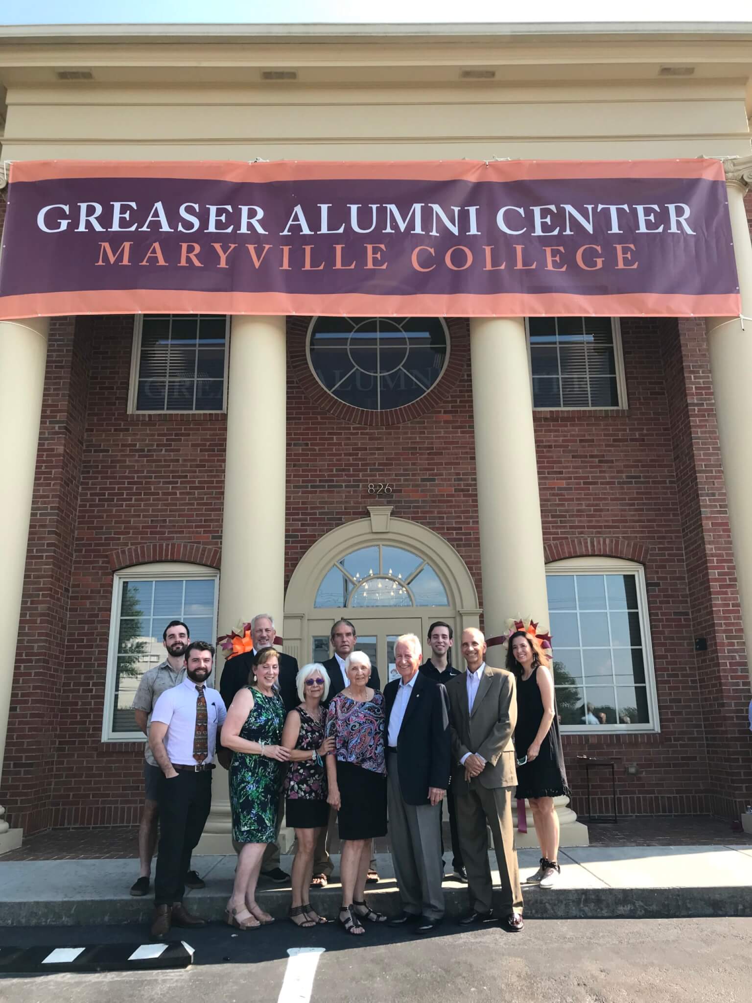 Photo of Greaser family in front of Greaser Alumni Center