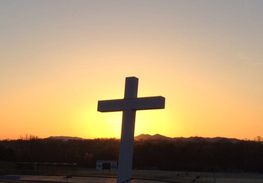 Photo of cross and sunrise on Lloyd Beach