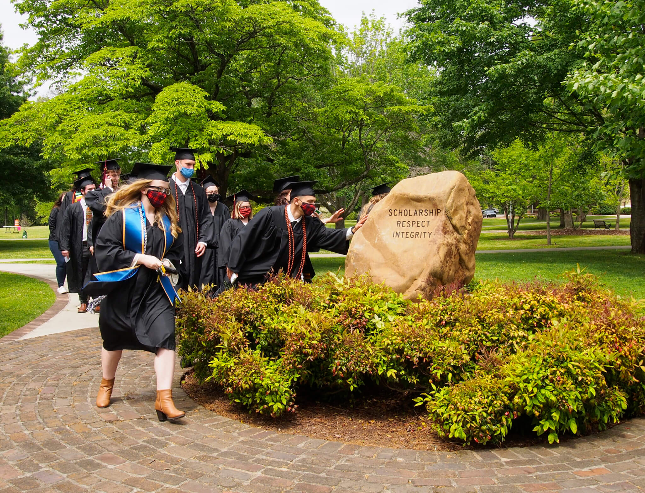 Photo of students touching Covenant Stone