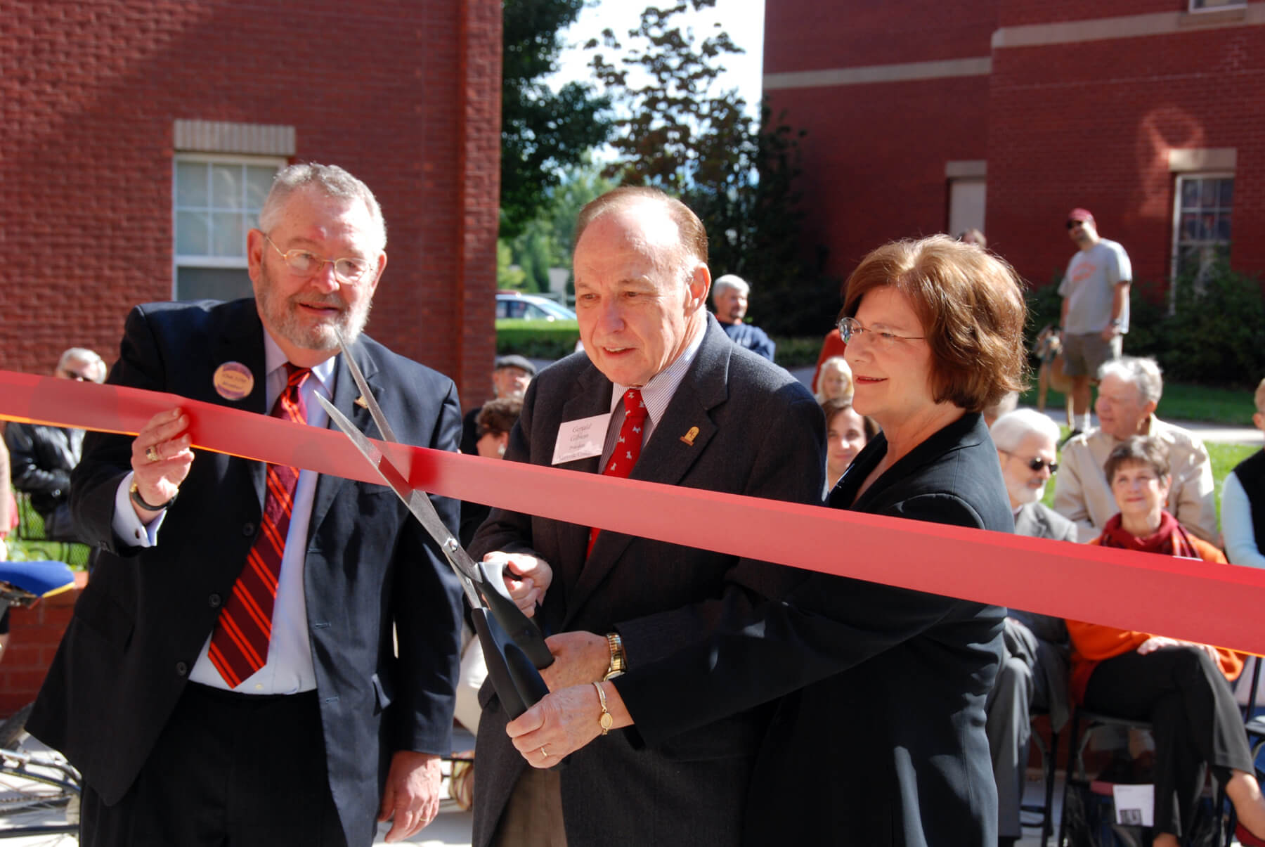 Dan Ellis ’60, Gerald and Rachel Gibson cut the ribbon on Gibson Hall