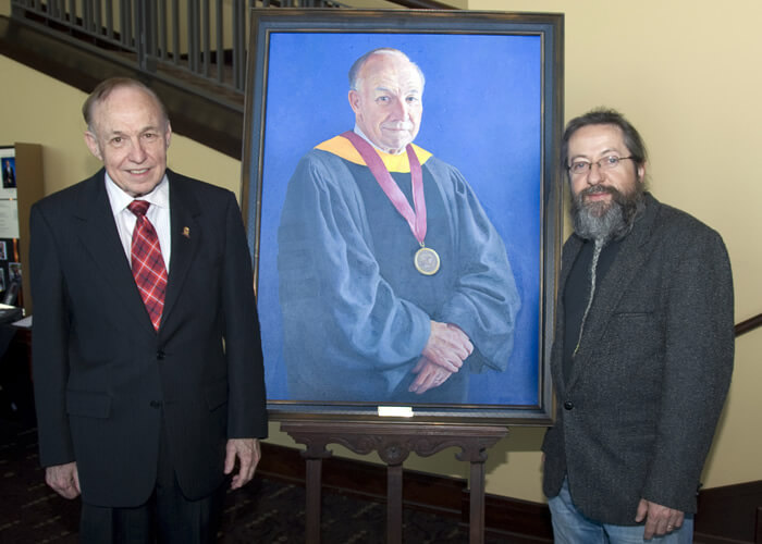 Dr. Gibson with Dr. Carl Gombert and the presidential portrait