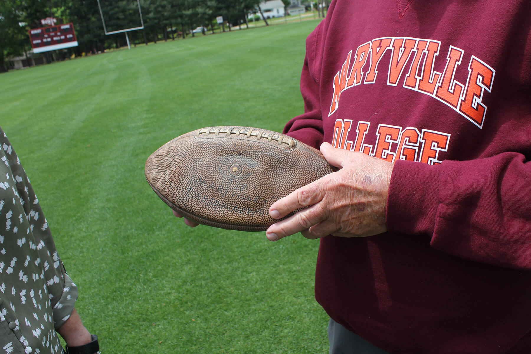 Photo of John Nichols holding football
