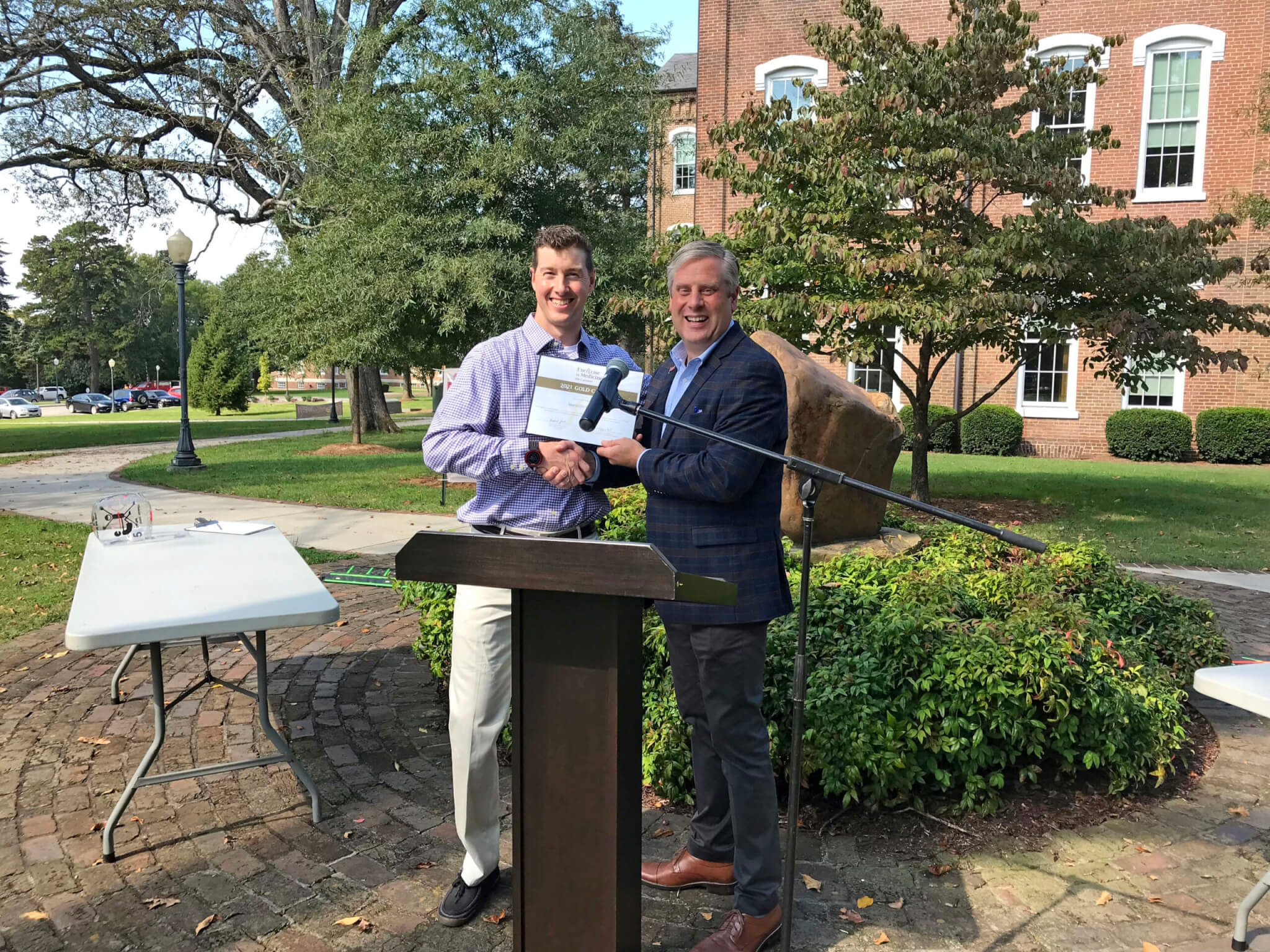 Dr. Jeremy Steeves and Dr. Bryan Coker at podium