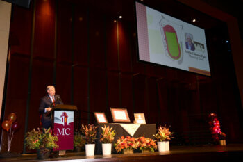 Photo of Dr. Bryan Coker making track and field announcement