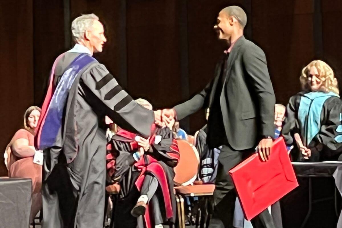 Photo of faculty member shaking hands