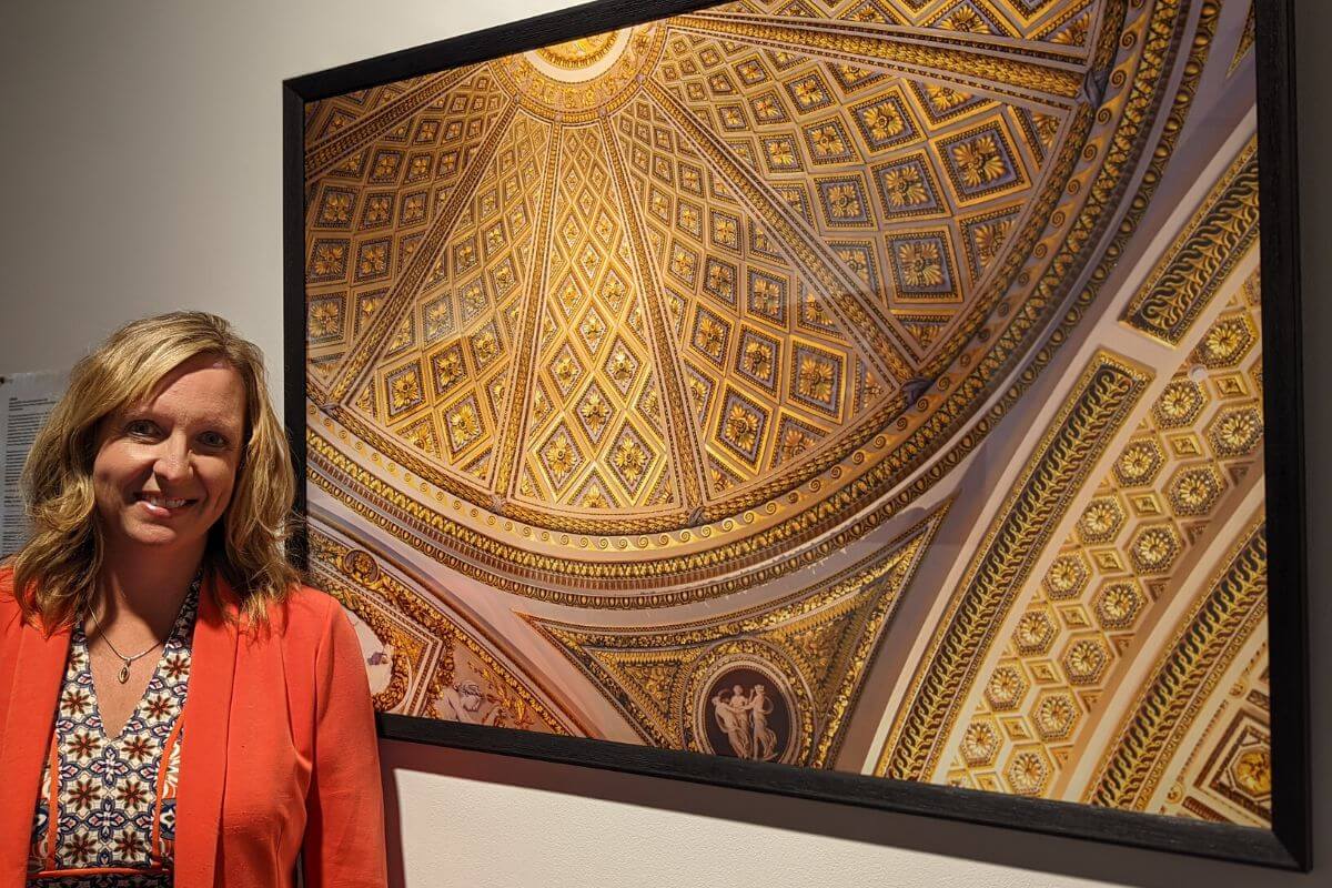 Photo of Adrienne Schwarte with one of her photographs