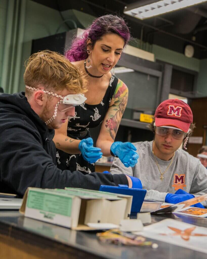 Photo of Dr. Joy Buongiorno helping students in a biology lab