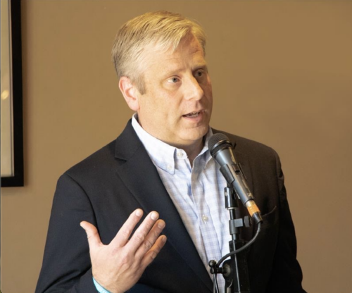 Photo of Dr. Bryan Coker at podium