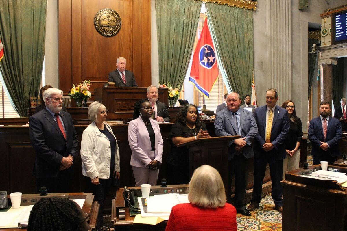 Photo of Senate resolution reading honoring Betty Asha