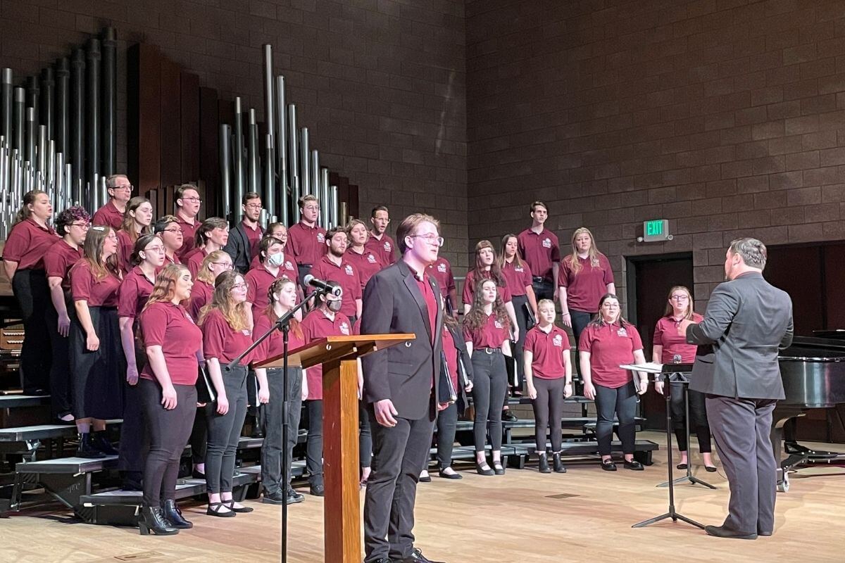 Photo of Connor Cowart directing recital choir