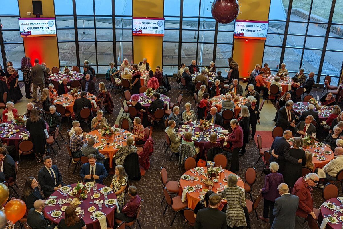 Photo of a crowded dinner ceremony in the Clayton Center