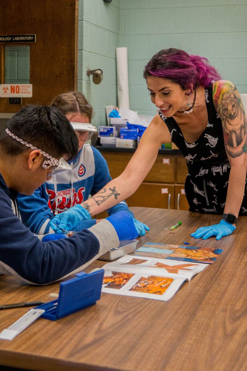 Photo of Joy Buongiorno working with students in the Sutton Science Center laboratories