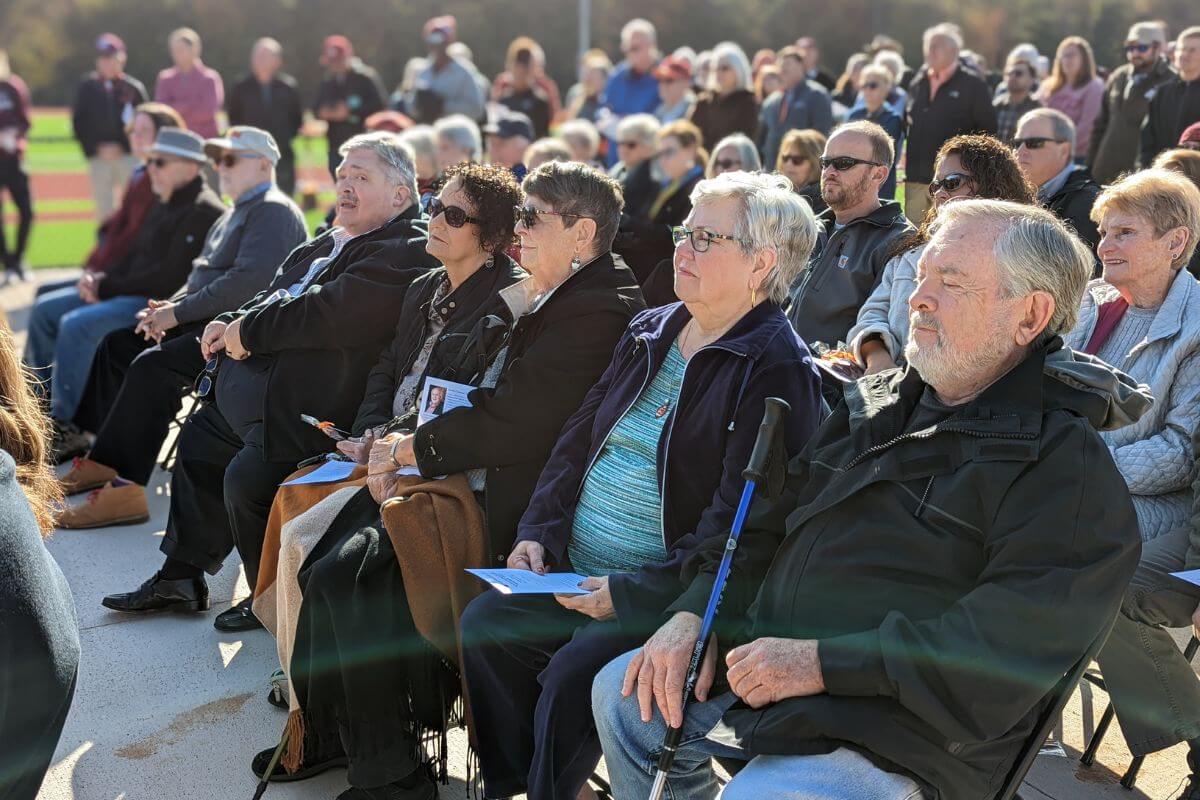 photo of a crowd listening to a speaker outdoors