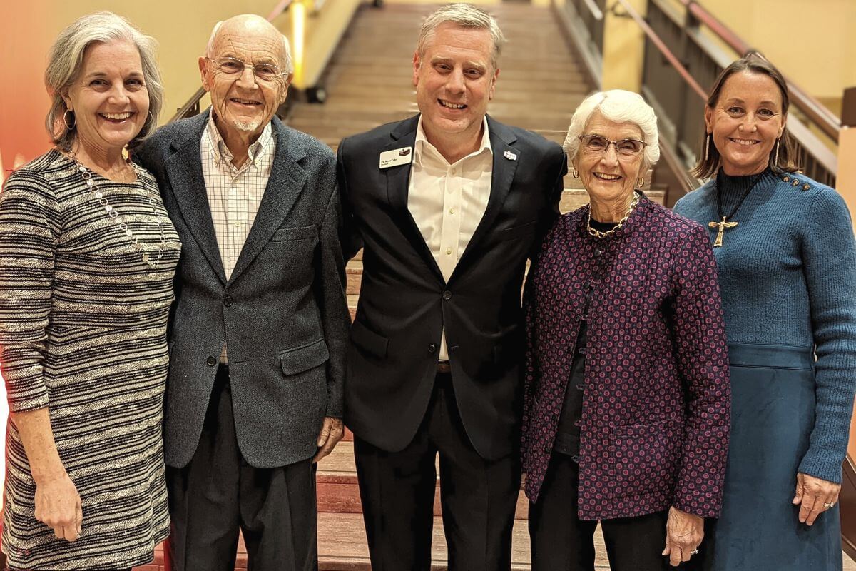 Photo of the Witherspoon family with Dr. Bryan Coker on the Clayton Center staircase