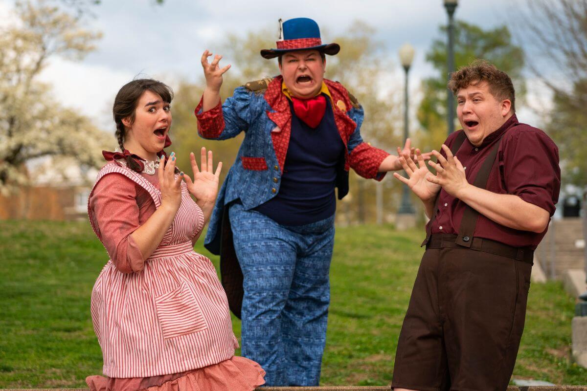 Photo of three MC students rehearsing the children's musical "Revolt of the Beavers"