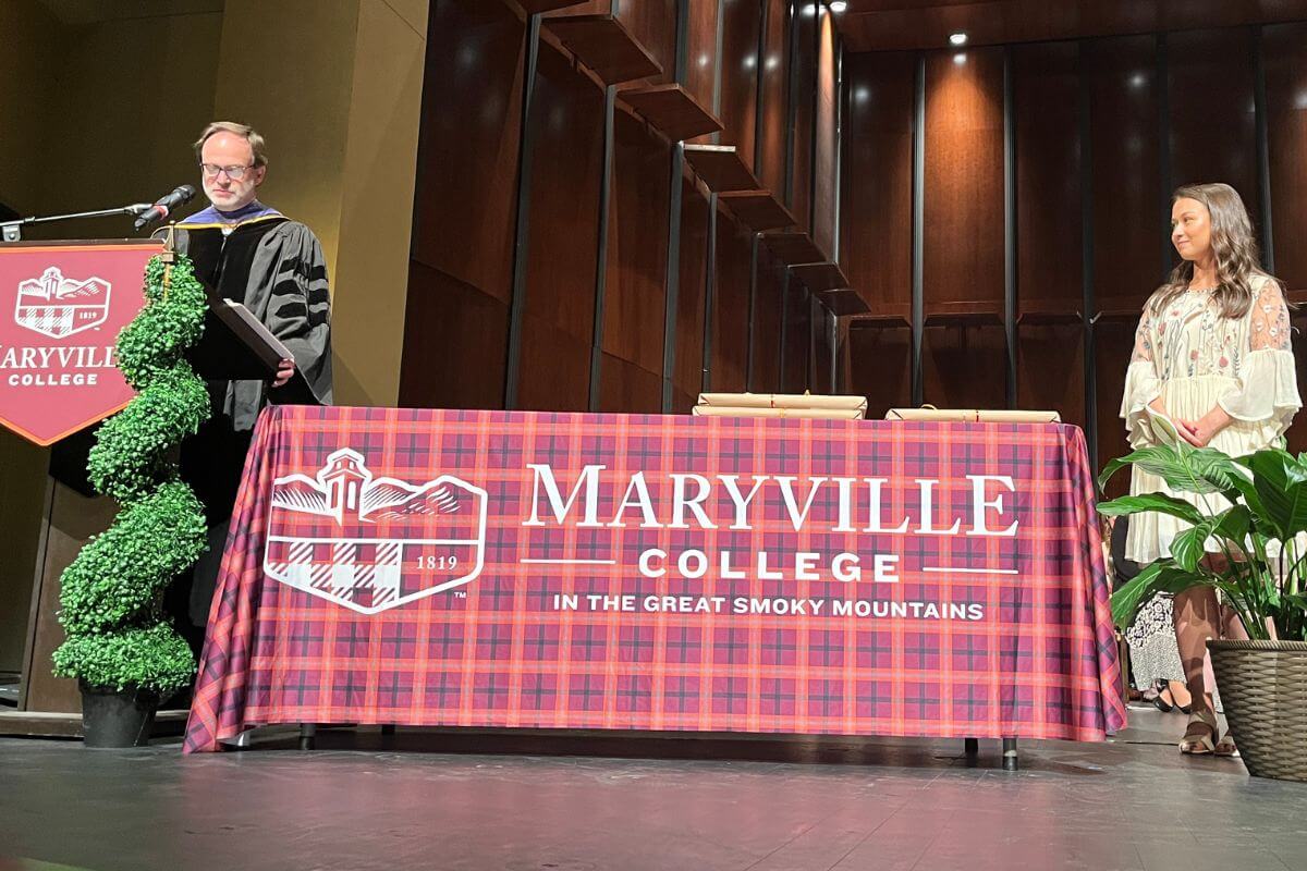 Photo of Dr. Scott Henson introducing Maddie Taylor on stage