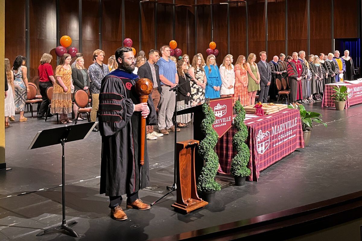 Photo of students filing onto the Clayton Center stage for the 2022-23 Academic Awards Ceremony.