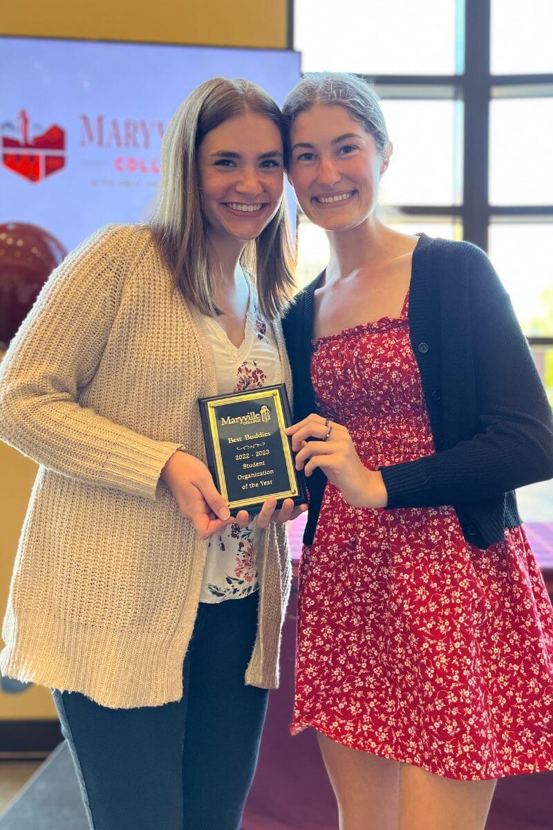 Photo of Lily Winebarger and Gabbie Noonan holding a plaque