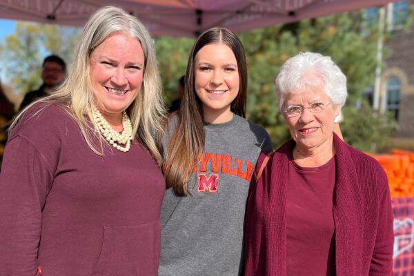 Photo of Grace Ann Kelly and her mother and grandmother at Homecoming 2022.
