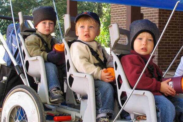 Photo of Hudson Moore in a stroller with two other toddlers
