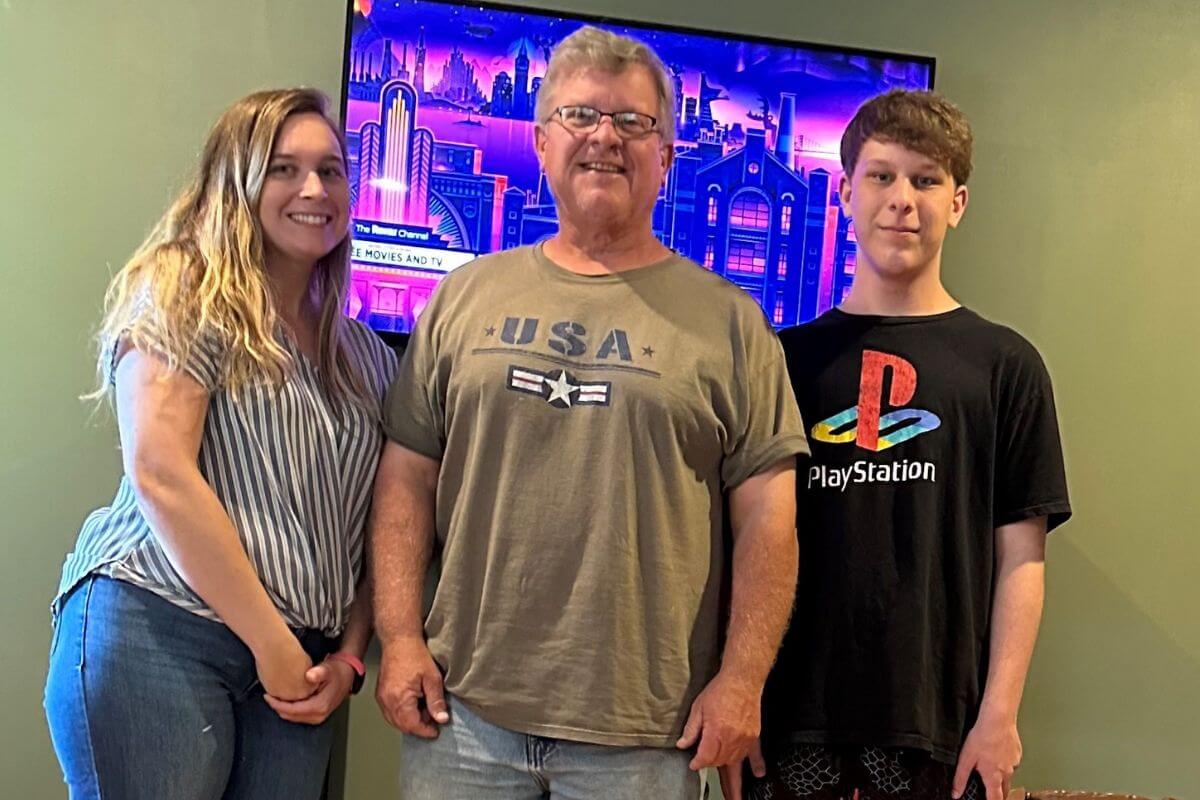 Photo of Levi Helton '27 with his sister and father