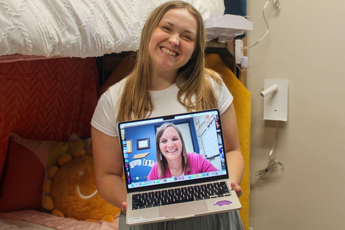 Marlee Giles holding a laptop with her aunt's face on it