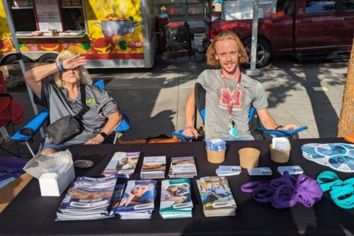Photo of Steve Cope at a table during a community event.