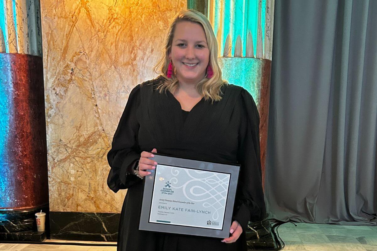 Photo of Emily Fain-Lynch '16 holding her Tennessee School Counselor of the Year certificate