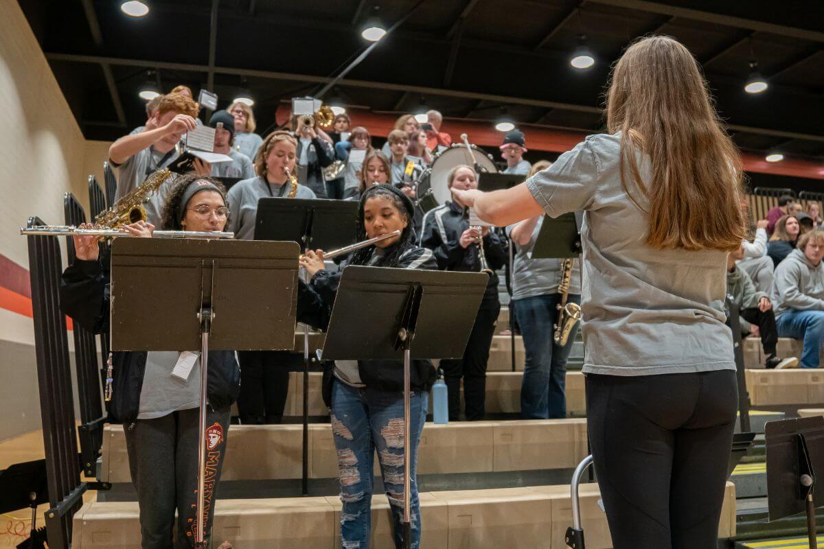 Photo of Leah Alsobrooks directing the pep band