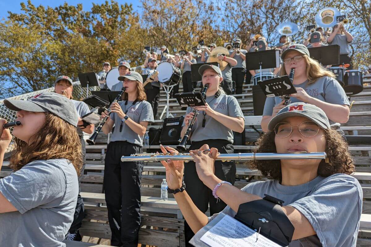 Photo of woodwind players in the MC Pep Band during a football game