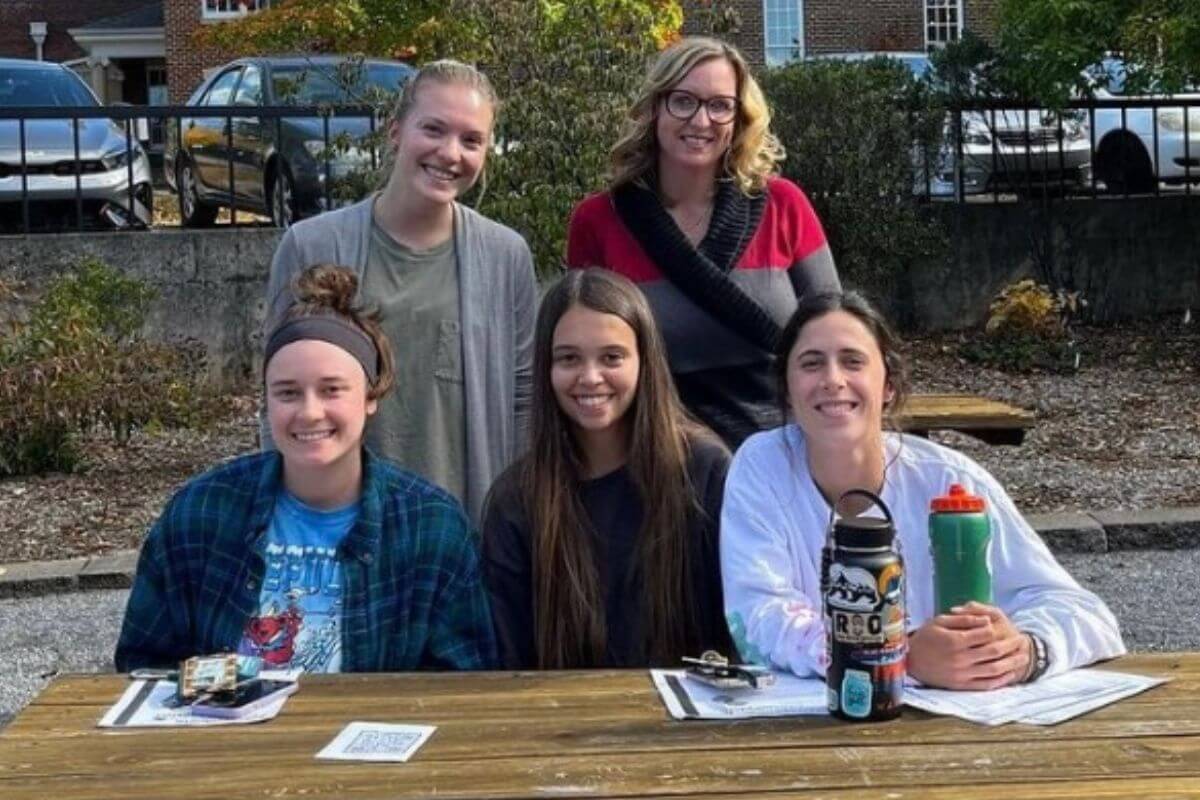 Photo of smiling Maryville College students at a picnic table