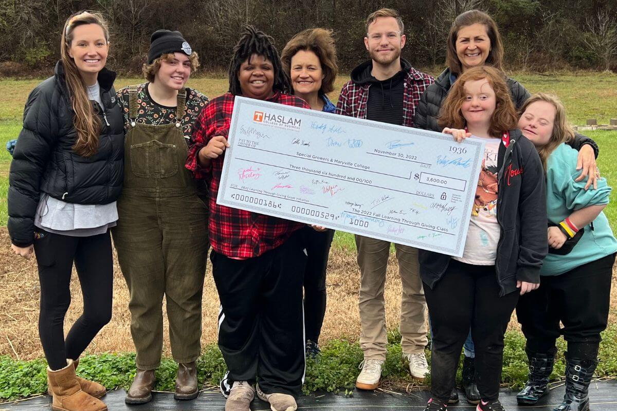 Photo of Special Growers staff members with the grant check from the UTK School of Business.